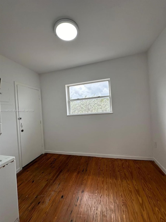 empty room featuring dark hardwood / wood-style flooring