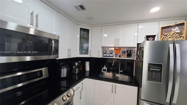 kitchen with white cabinetry, stainless steel appliances, and sink