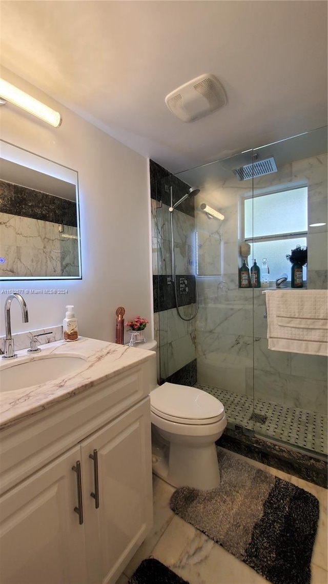 bathroom with vanity, toilet, and walk in shower