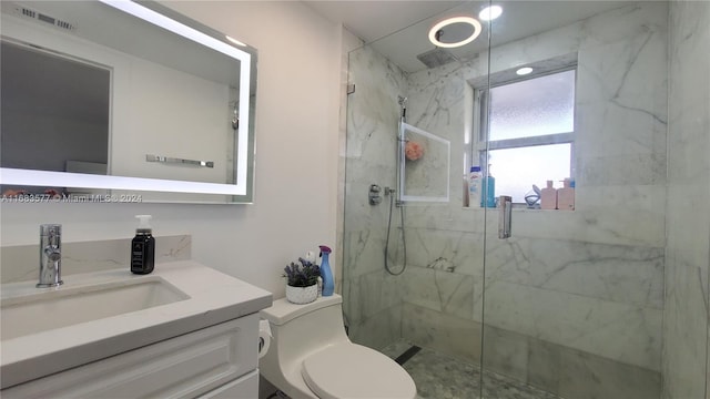 bathroom featuring vanity, toilet, and walk in shower