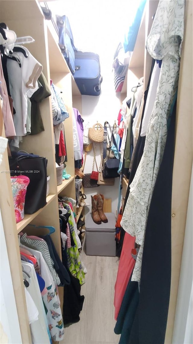 spacious closet featuring hardwood / wood-style flooring