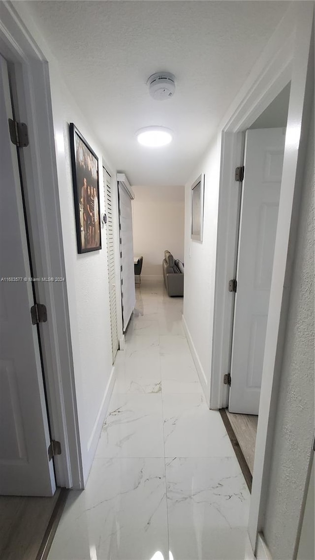 hallway featuring a textured ceiling