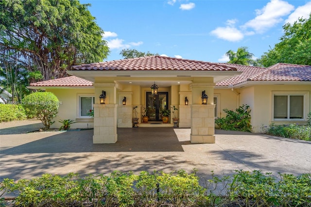 view of front of home featuring a tiled roof and stucco siding