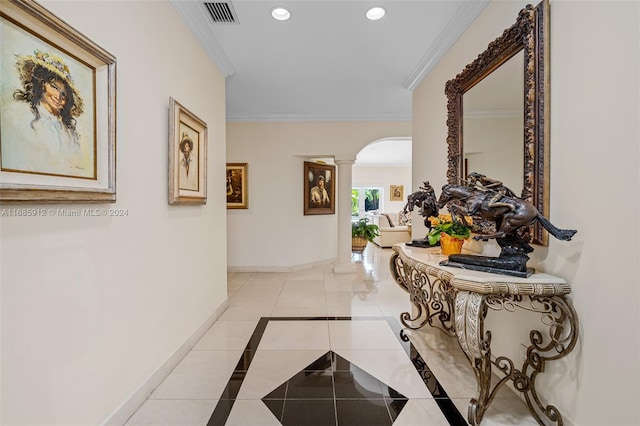 hall with arched walkways, tile patterned floors, baseboards, ornate columns, and ornamental molding