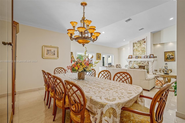 dining space featuring an inviting chandelier, a fireplace, light tile patterned floors, lofted ceiling, and visible vents