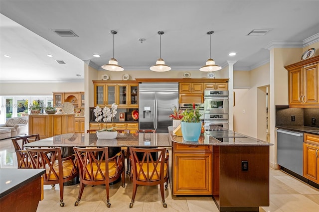 kitchen featuring crown molding, visible vents, brown cabinets, tasteful backsplash, and stainless steel appliances