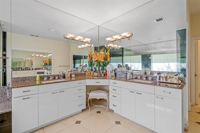 bathroom with visible vents, an inviting chandelier, and vanity