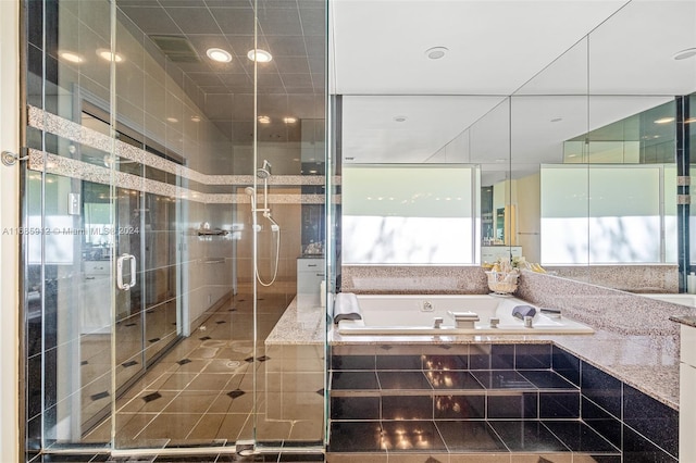 full bath with a garden tub and a stall shower