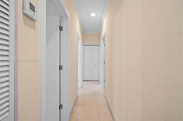 hall featuring attic access, light tile patterned floors, baseboards, ornamental molding, and recessed lighting