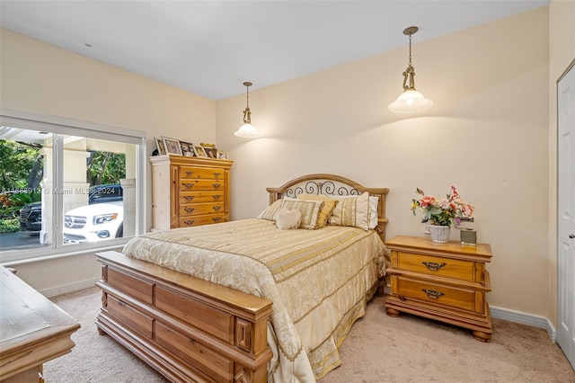 bedroom featuring baseboards and light carpet