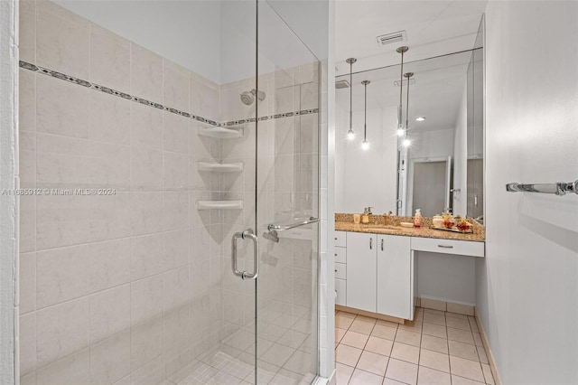 full bathroom with visible vents, tile patterned floors, a stall shower, and vanity