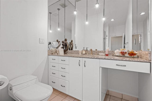 bathroom with a walk in shower, toilet, tile patterned floors, and vanity