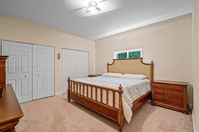 bedroom with carpet and multiple closets