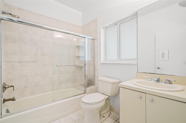 full bath with vanity, enclosed tub / shower combo, tile patterned floors, and toilet
