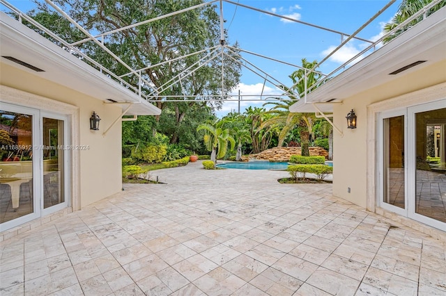 view of patio featuring a lanai and an outdoor pool