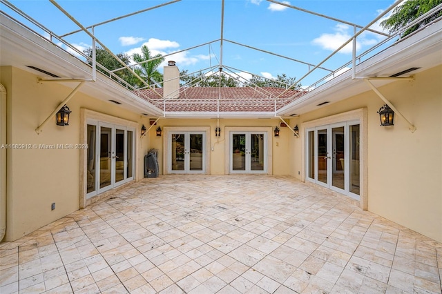 unfurnished sunroom with french doors