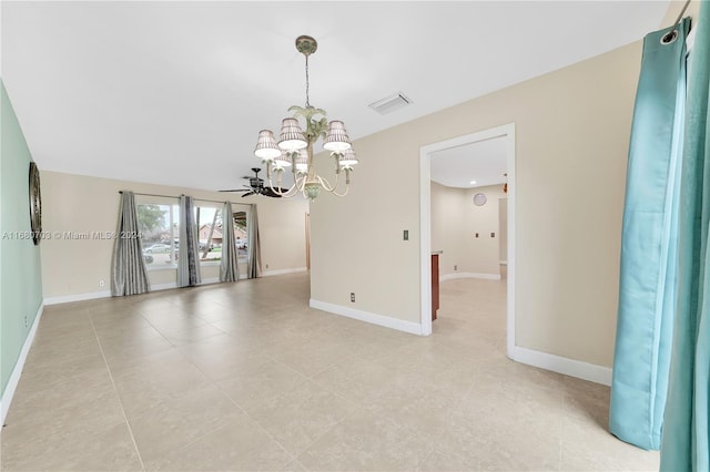 spare room featuring light tile patterned flooring and ceiling fan with notable chandelier