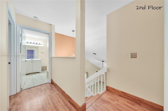 hallway with hardwood / wood-style floors