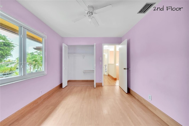 unfurnished bedroom featuring a closet, ceiling fan, and light hardwood / wood-style flooring