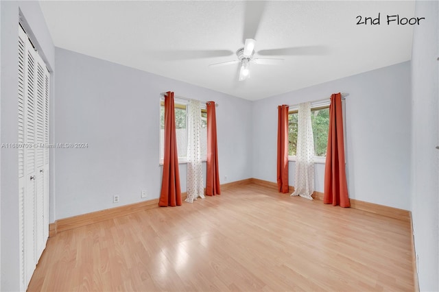 interior space with a closet, ceiling fan, and light hardwood / wood-style floors