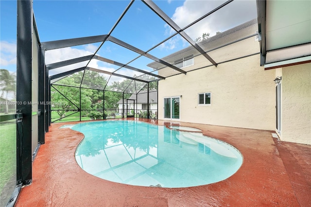 view of swimming pool featuring a patio area and glass enclosure