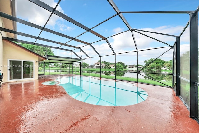 view of swimming pool with a patio area, a water view, and glass enclosure