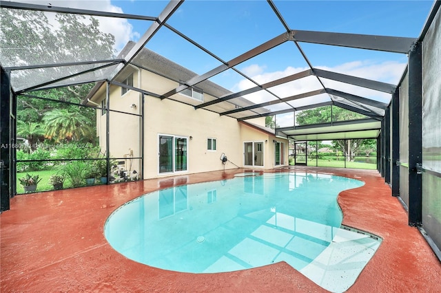 view of pool featuring a patio and glass enclosure