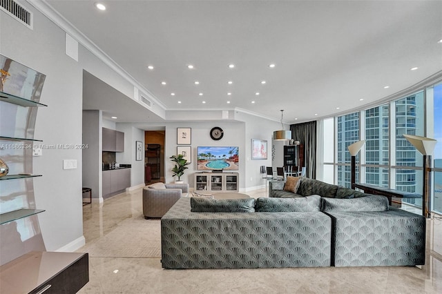 living room featuring a wall of windows, ornamental molding, and a wealth of natural light