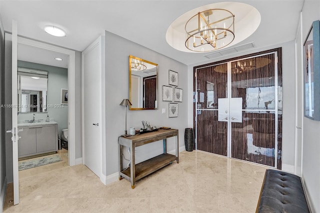 interior space with sink, an inviting chandelier, and light tile patterned floors