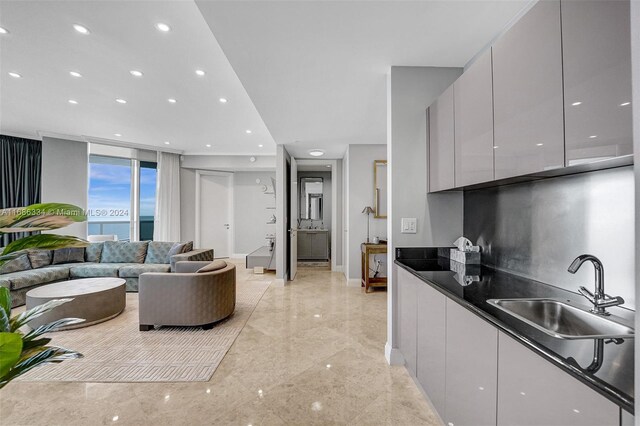 kitchen featuring white cabinets, sink, and a water view