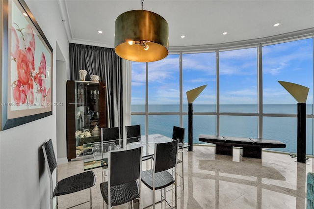 dining space with expansive windows, ornamental molding, and a water view