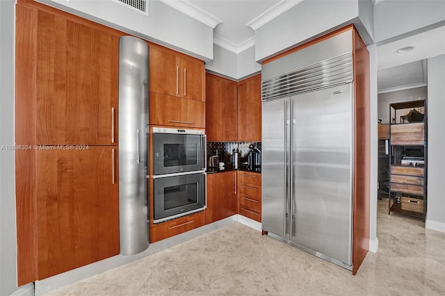 kitchen featuring crown molding, stainless steel appliances, and tasteful backsplash