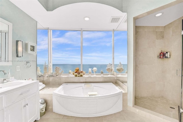 bathroom featuring vanity, separate shower and tub, a water view, and tile patterned floors