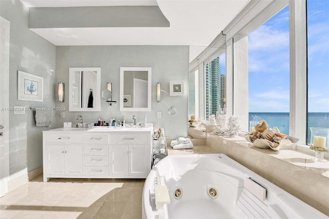 bathroom with vanity, a tub, and a water view