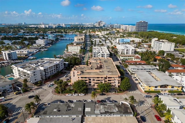 birds eye view of property featuring a water view and a view of city