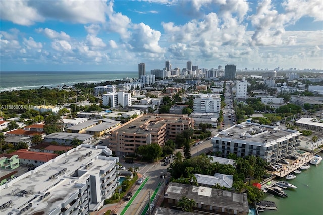 birds eye view of property featuring a water view and a view of city