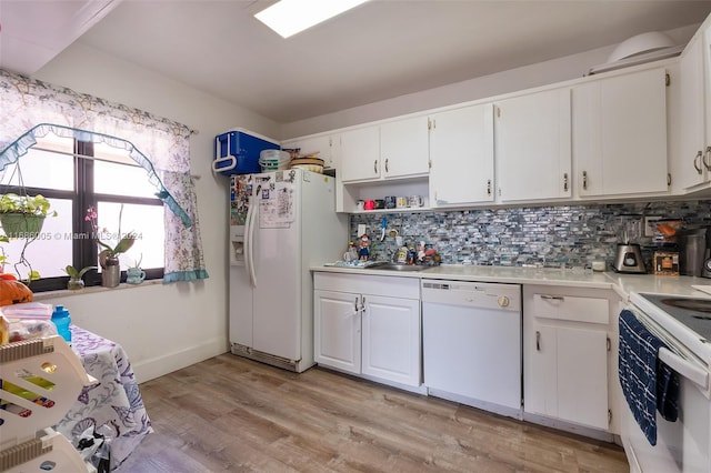 kitchen with backsplash, white appliances, light countertops, and white cabinets