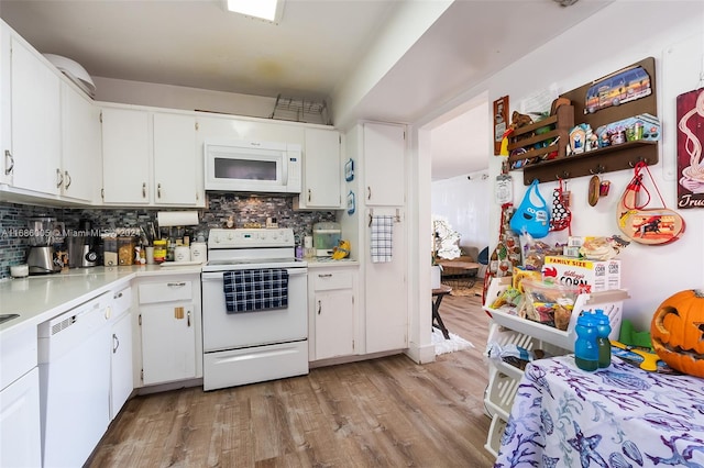 kitchen featuring light hardwood / wood-style floors, white cabinets, tasteful backsplash, and white appliances