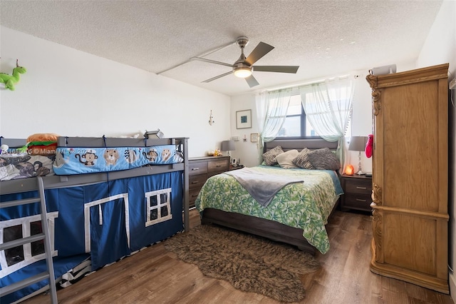 bedroom with dark hardwood / wood-style flooring, a textured ceiling, and ceiling fan