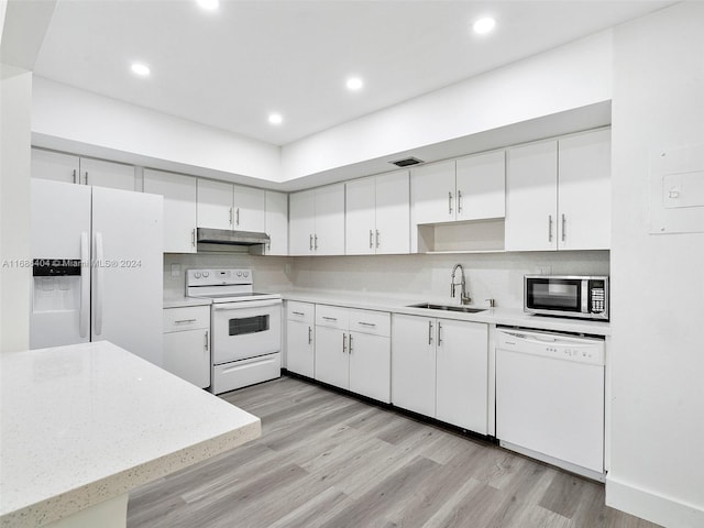 kitchen with white cabinetry, white appliances, sink, and light wood-type flooring