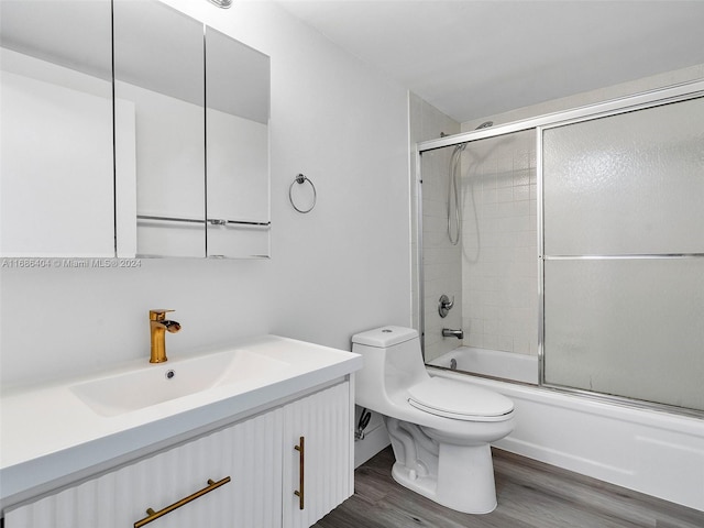 full bathroom with shower / bath combination with glass door, vanity, toilet, and wood-type flooring