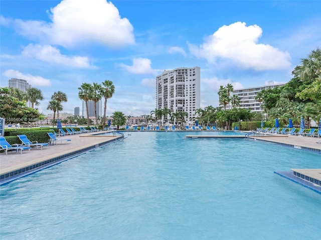 view of swimming pool featuring a water view