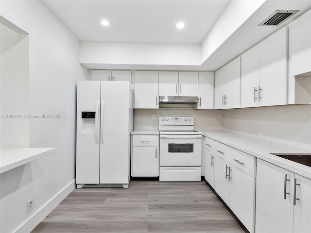 kitchen with white cabinetry, decorative backsplash, light hardwood / wood-style flooring, and white appliances