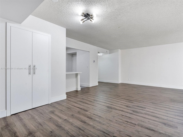 interior space featuring a textured ceiling and hardwood / wood-style flooring