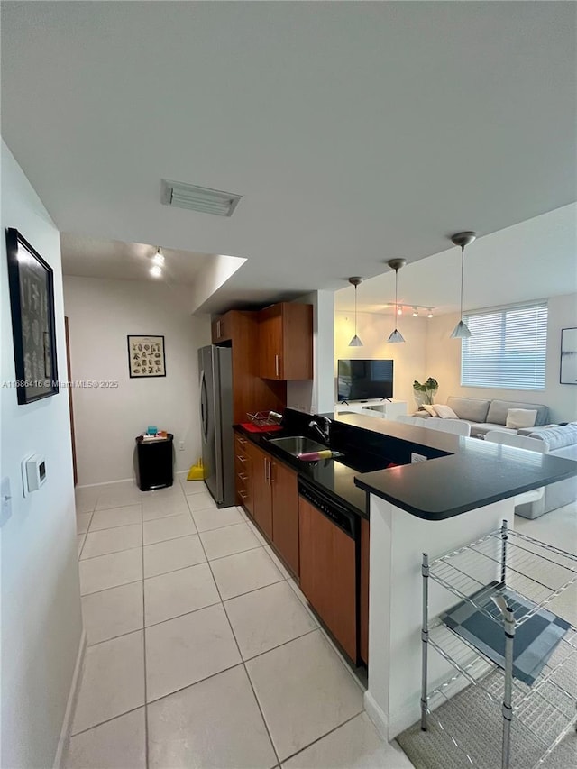 kitchen with a kitchen breakfast bar, open floor plan, freestanding refrigerator, dark countertops, and paneled dishwasher