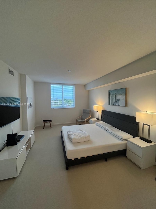 bedroom featuring light carpet, baseboards, and visible vents