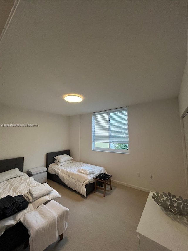 bedroom with carpet and baseboards