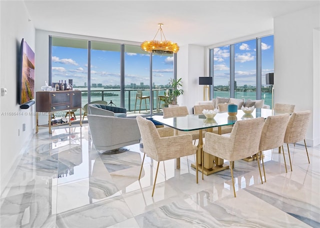 dining space with expansive windows, a healthy amount of sunlight, and a water view