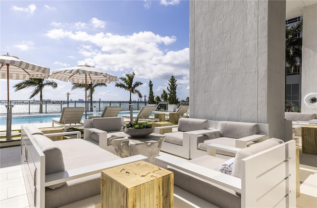 view of patio featuring a water view and a beach view