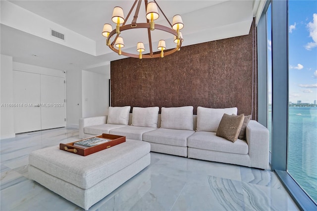 living room with a water view and an inviting chandelier